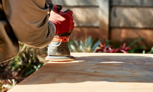 An electric sander being used.